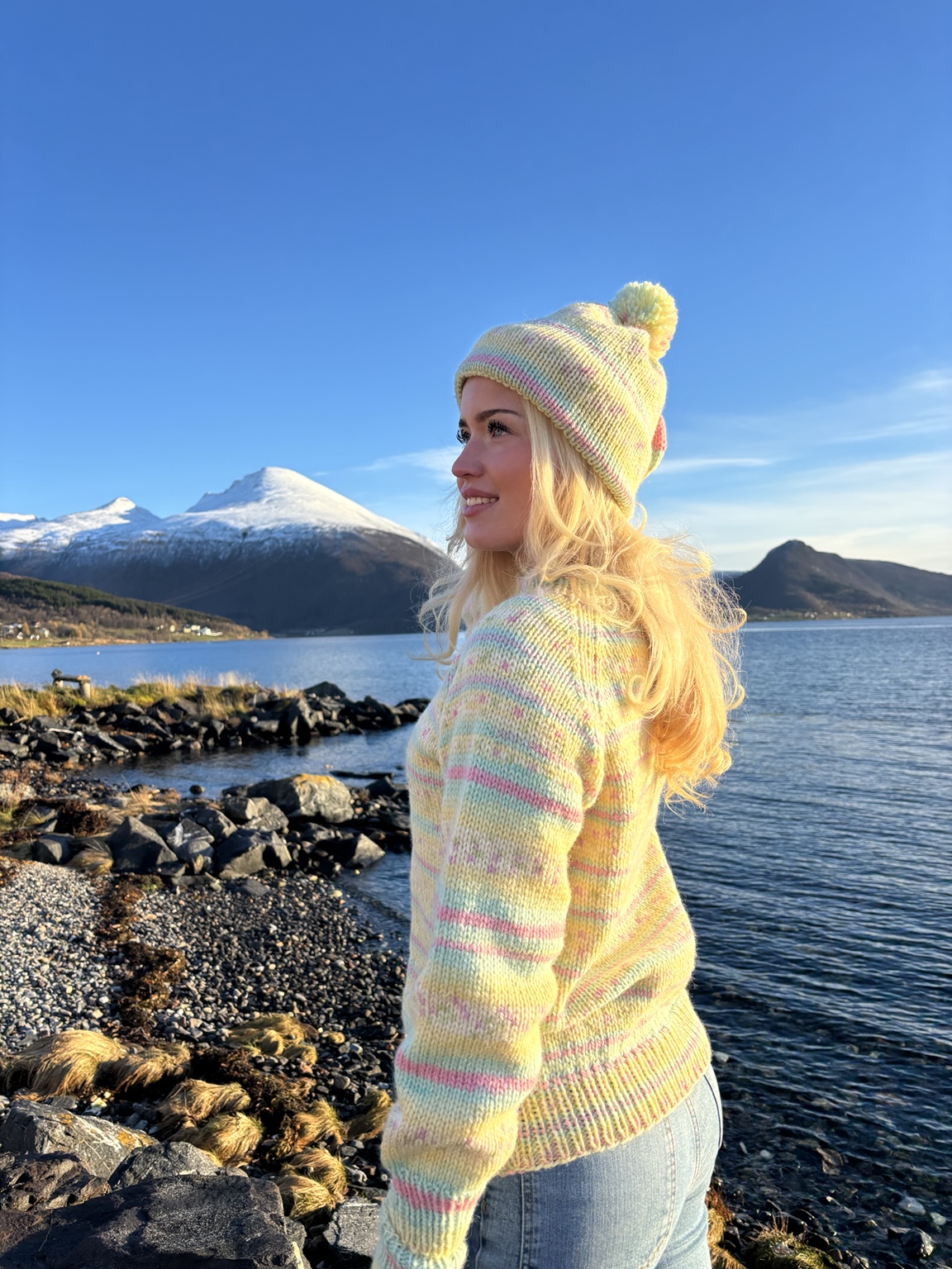 Pastel hand-knitted wool sweater by the fjord in Tromsø